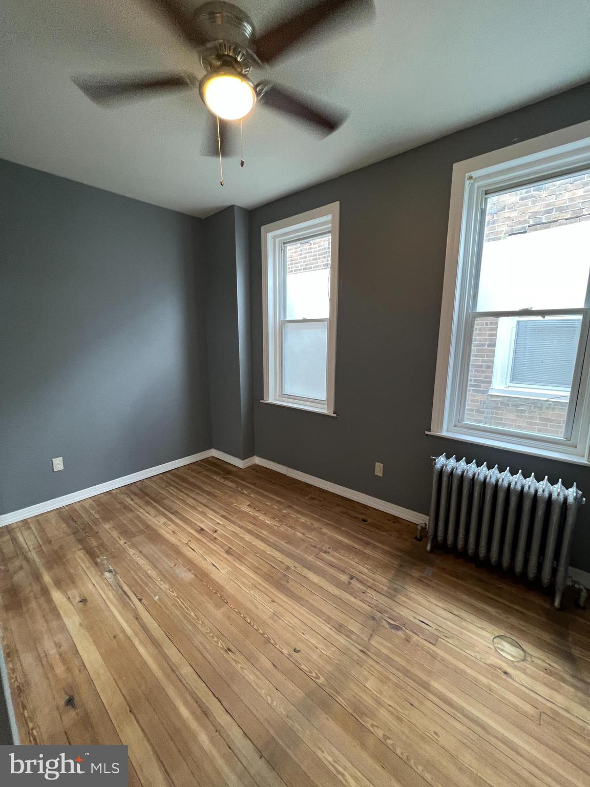 5931 Carpenter Street Philadelphia, PA 19143 - Photo 11 of 15 a view of an empty room with window and wooden floor