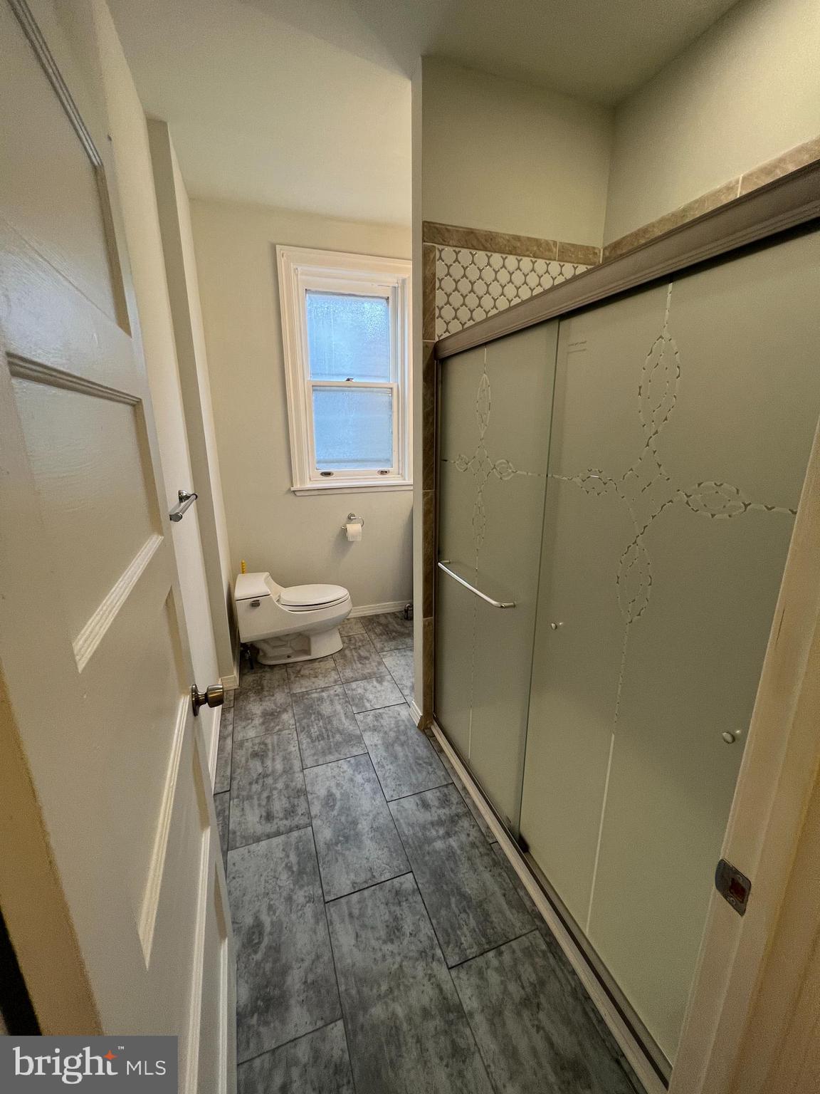 5931 Carpenter Street Philadelphia, PA 19143 - Photo 12 of 15 a bathroom with a granite countertop shower and a sink