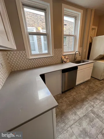 a kitchen with stainless steel appliances granite countertop a refrigerator sink and cabinets