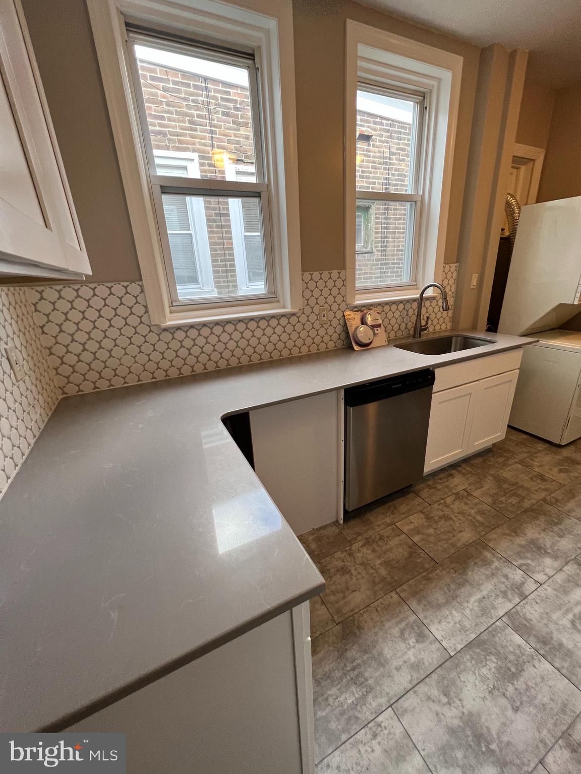 5931 Carpenter Street Philadelphia, PA 19143 - Photo 8 of 15 a living room with stainless steel appliances furniture cabinets and a window