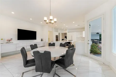 a spacious bedroom with a bed and a chandelier