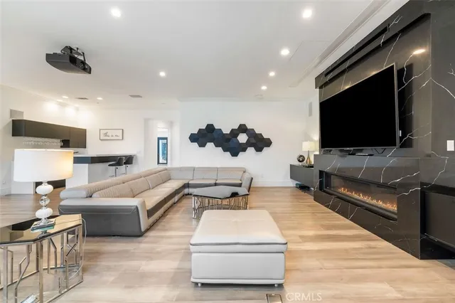a view of a livingroom with wooden floor and a flat screen tv