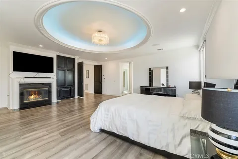 a bedroom with furniture and a large window