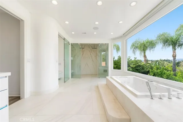 a bathroom with a granite countertop sink and a large mirror