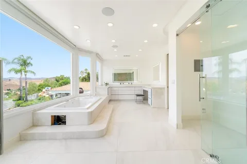 a bathroom with a granite countertop sink and a large mirror