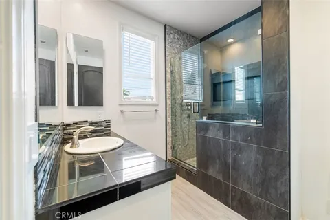 a bathroom with a double vanity sink and a mirror