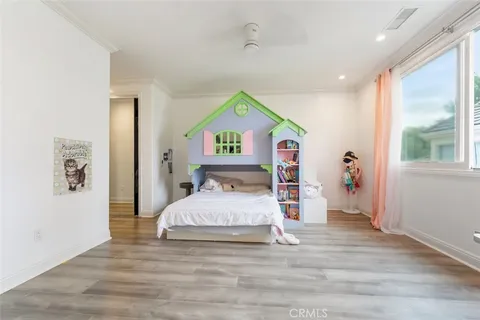 a bedroom with a bed and a large window