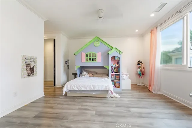 a bedroom with a bed and a large window