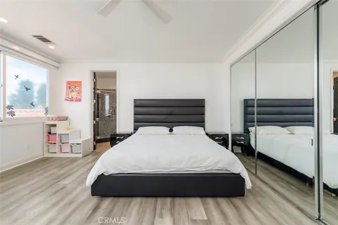 a bed room with a bed a television and a large window