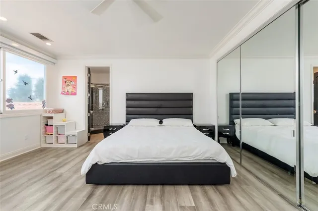 a bed room with a bed a television and a large window