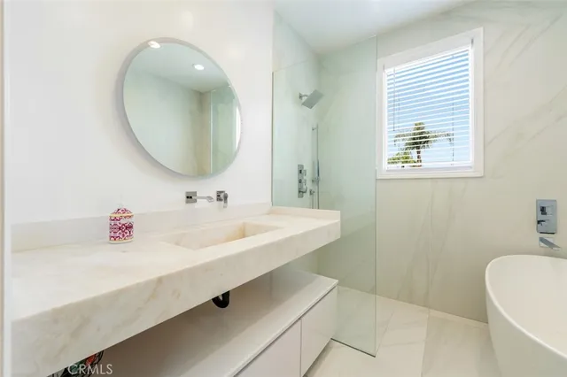 a living room with furniture floor to ceiling window next to a yard