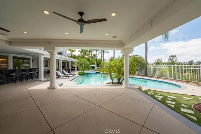 a view of a swimming pool and lounge chairs