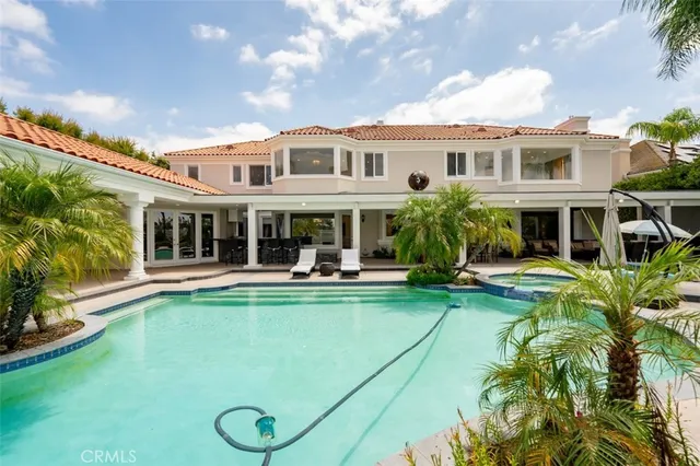 a view of a house with backyard and sitting area