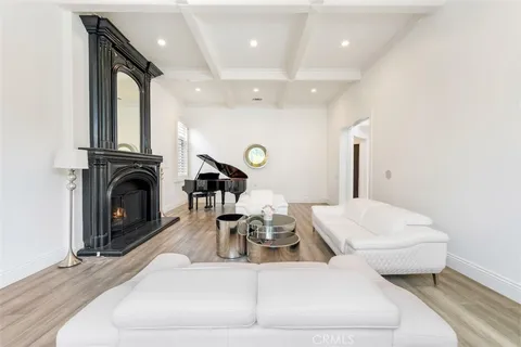 a living room with furniture a fireplace and a large mirror