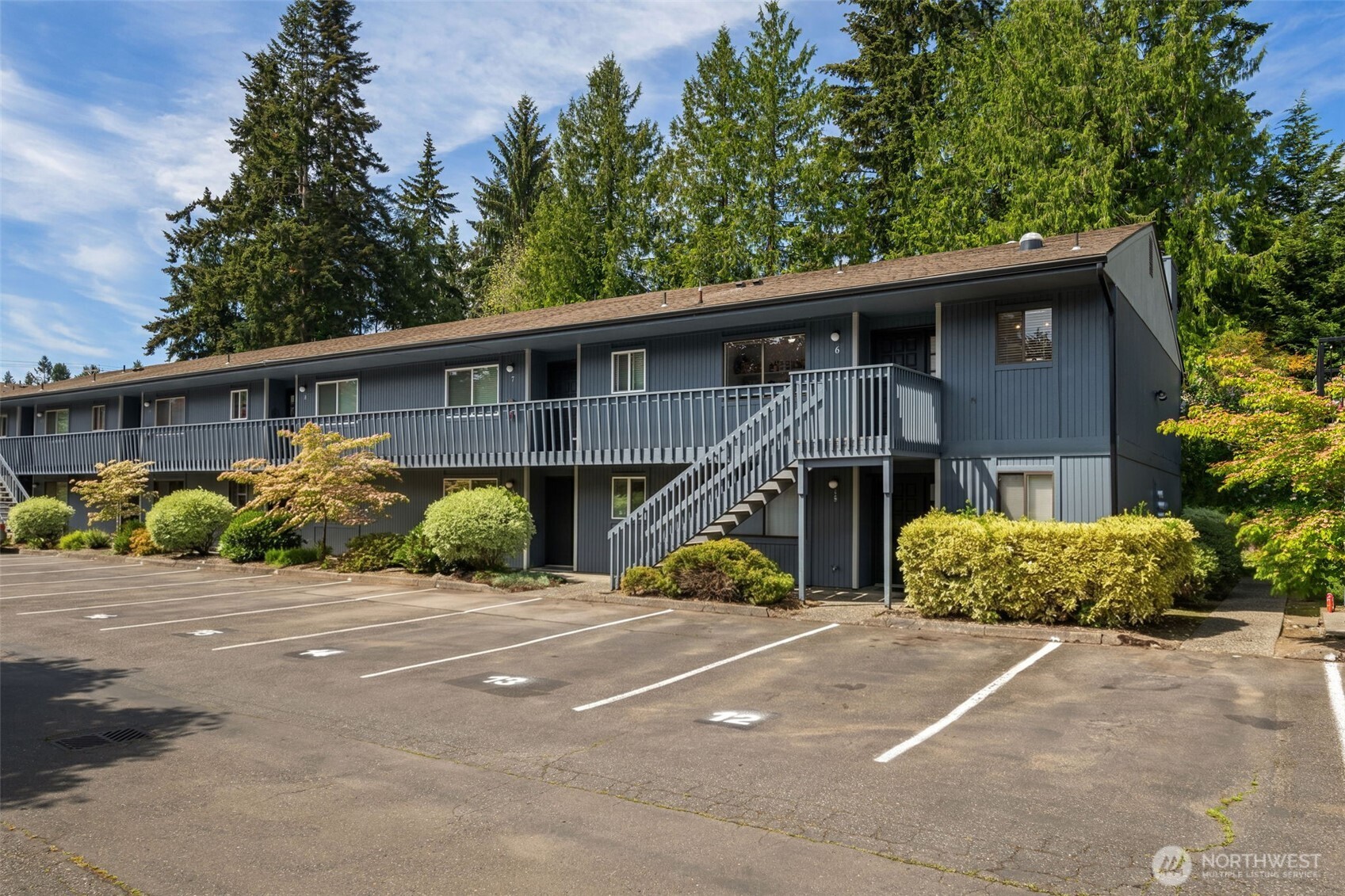 8017 196th Street Southwest, Unit 6B Edmonds, WA 98026 - Photo 22 of 23 a view of a house with potted plants and large windows