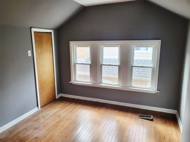 a view of hallway with stairs and wooden floor
