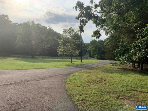 a view of a big yard with trees