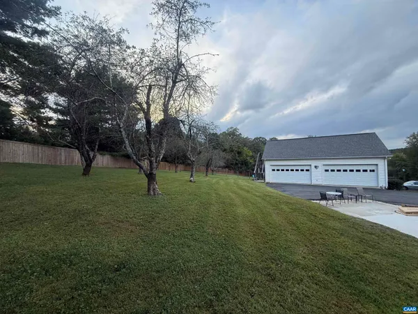a front view of a house with a yard table and chairs
