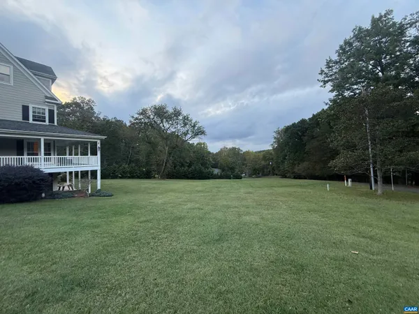 a kitchen with stainless steel appliances granite countertop a sink cabinets and wooden floor