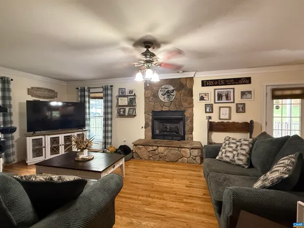 a room with wooden floor and furniture