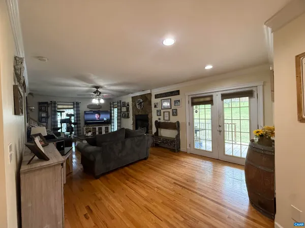 a spacious bedroom with a bed and a mirror on the dresser