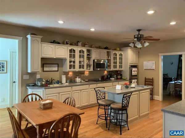 a kitchen that has a table and chairs in it
