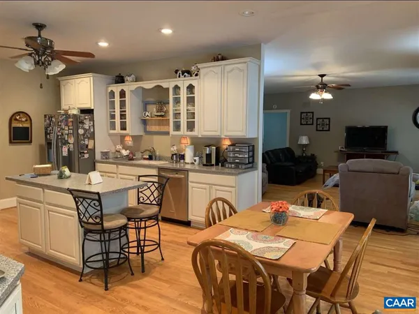a kitchen with stainless steel appliances granite countertop a refrigerator and a stove top oven