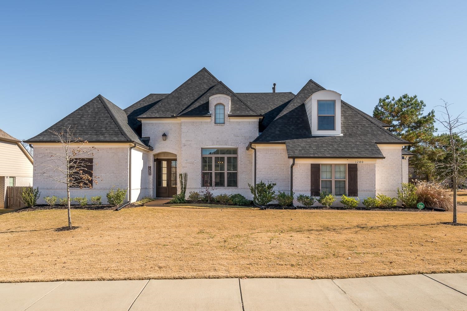 1280 Mountain Side Drive Collierville, TN 38017 - Photo 1 of 25 a front view of a house with garden