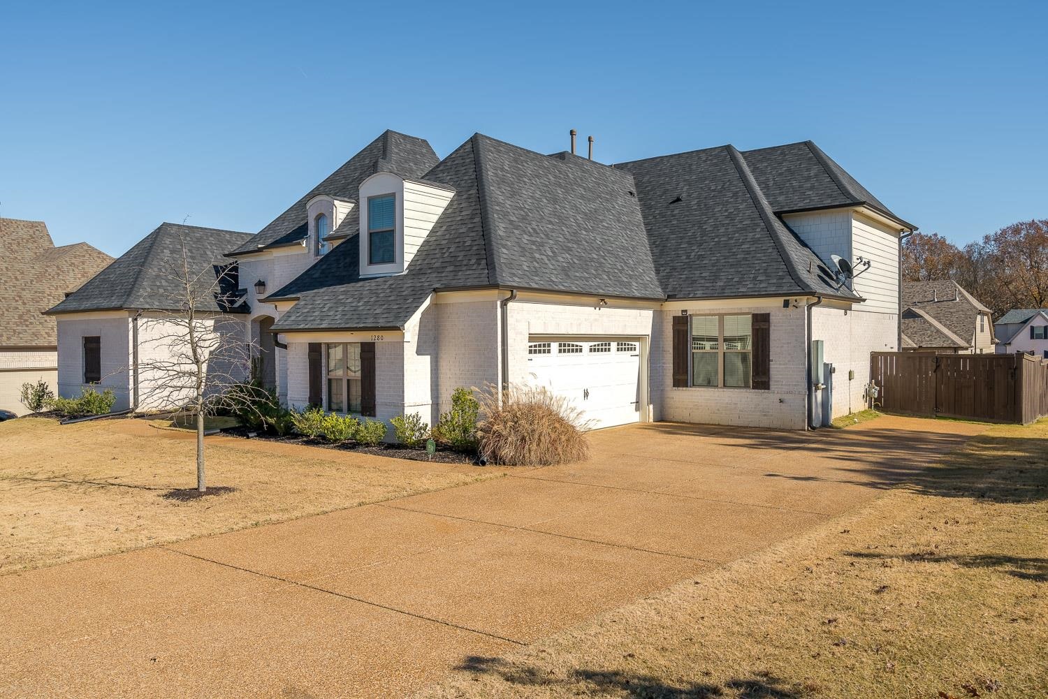 1280 Mountain Side Drive Collierville, TN 38017 - Photo 2 of 25 a front view of a house with a yard and garage