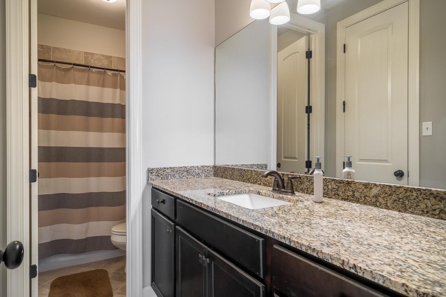 1280 Mountain Side Drive Collierville, TN 38017 - Photo 16 of 25 a bathroom with a granite countertop sink and a mirror