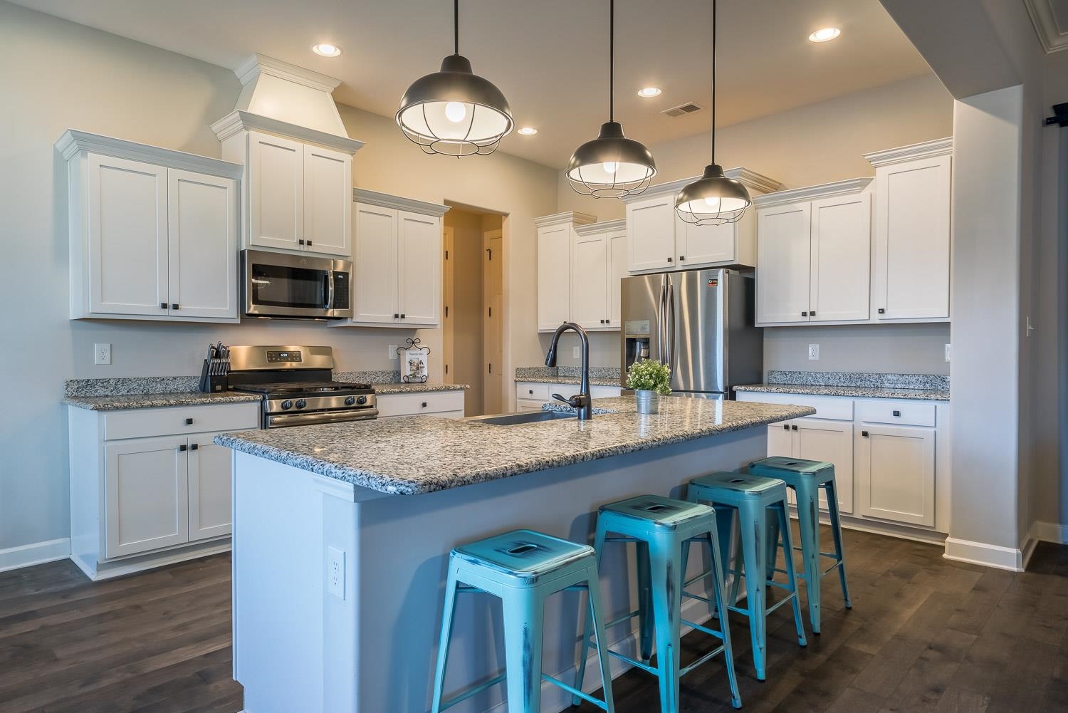 1280 Mountain Side Drive Collierville, TN 38017 - Photo 9 of 25 a kitchen with stainless steel appliances granite countertop a sink a stove a refrigerator cabinets and chairs