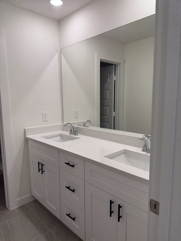 3134 Emerald Hls Drive Angleton, TX 77515 - Photo 6 of 7 a bathroom with a sink and a mirror