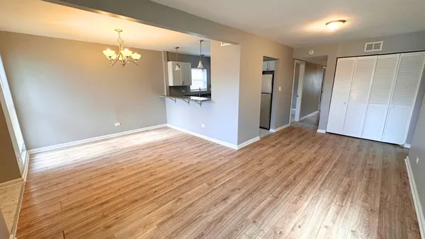 a view of a room with wooden floor and staircase