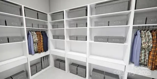 a view of walk in closet with clothes and shoes