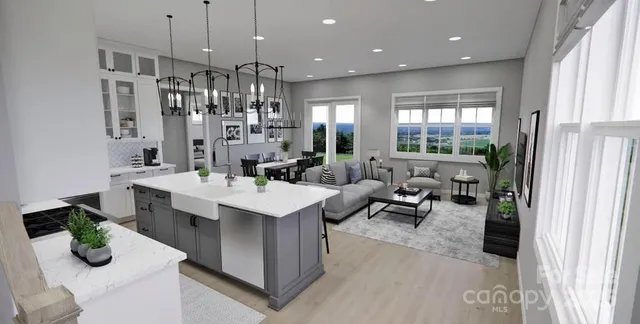 a kitchen with counter top space and living room view
