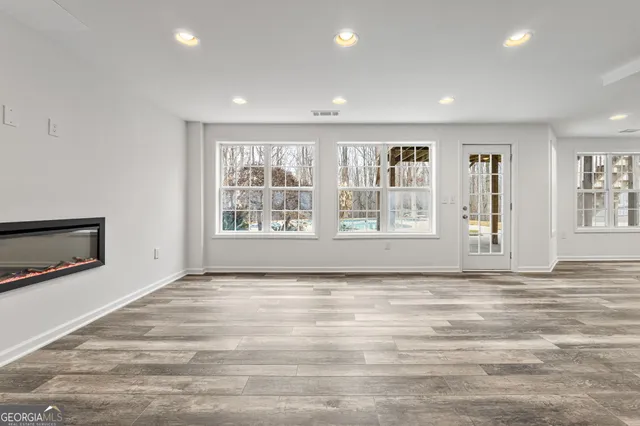 a spacious bathroom with a tub shower and window