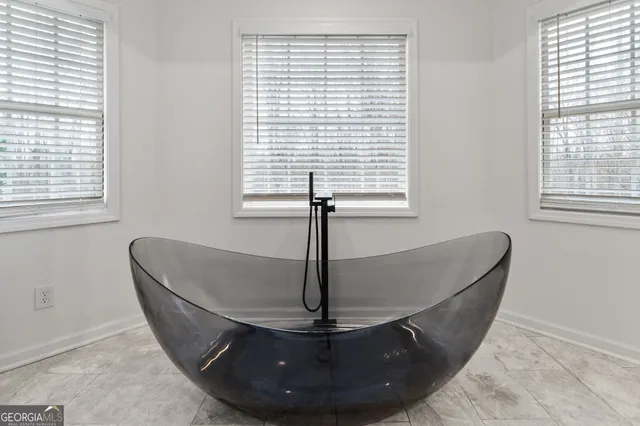 a living room with stainless steel appliances kitchen island granite countertop wooden floor and view kitchen