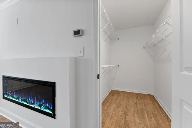 a view of empty room with wooden floor and fireplace