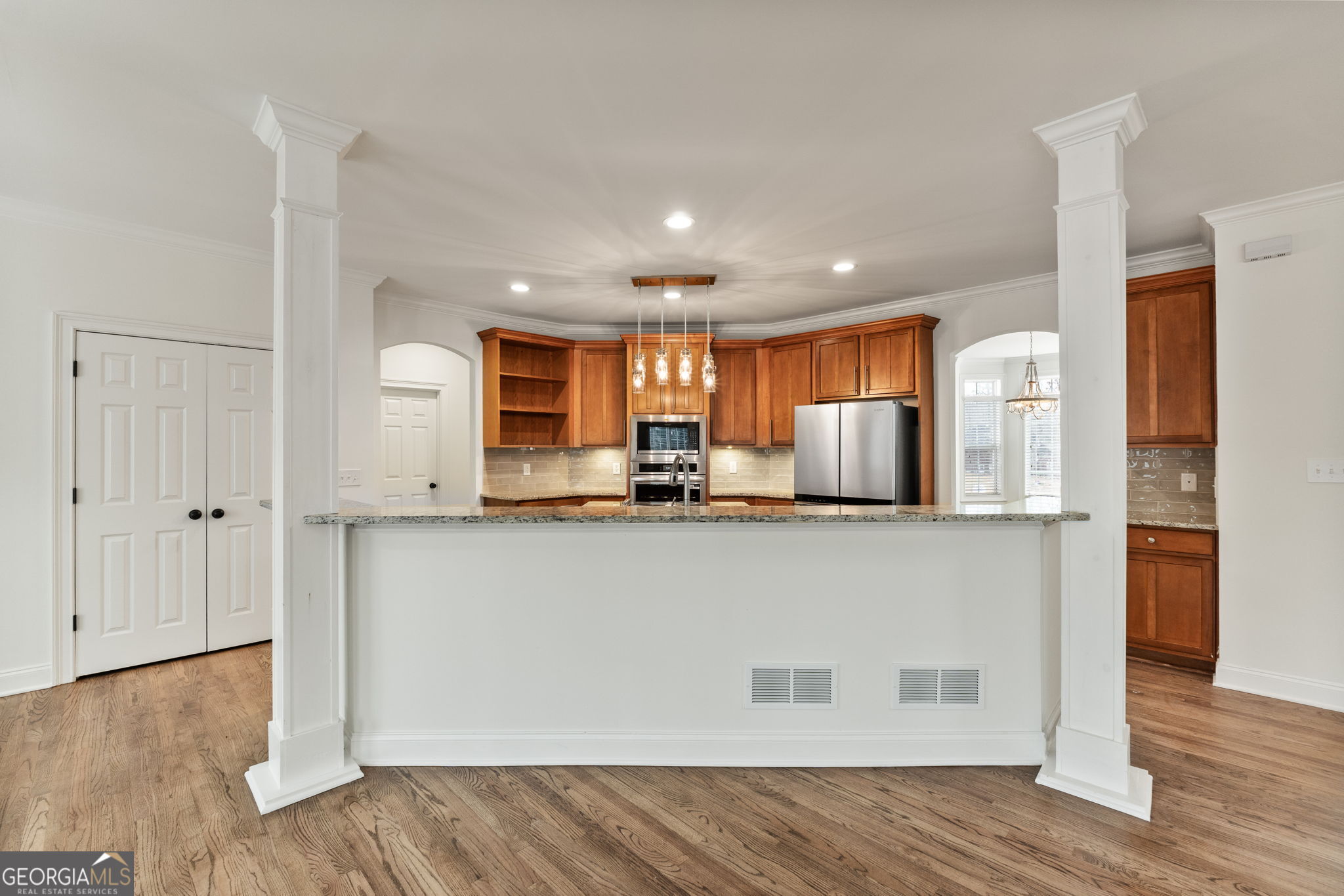 280 Antebellum Way Fayetteville, GA 30215 - Photo 39 of 65 a living room with stainless steel appliances kitchen island granite countertop wooden floor and view kitchen