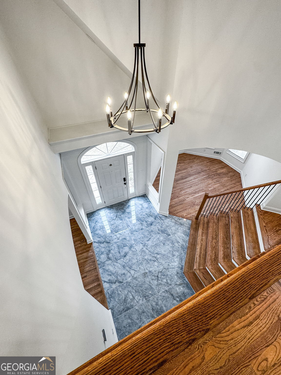 280 Antebellum Way Fayetteville, GA 30215 - Photo 52 of 65 a view of staircase with kitchen island stainless steel appliances wooden floor and chandelier