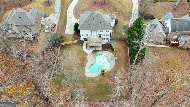 wooden floor in an entryway with a chandelier