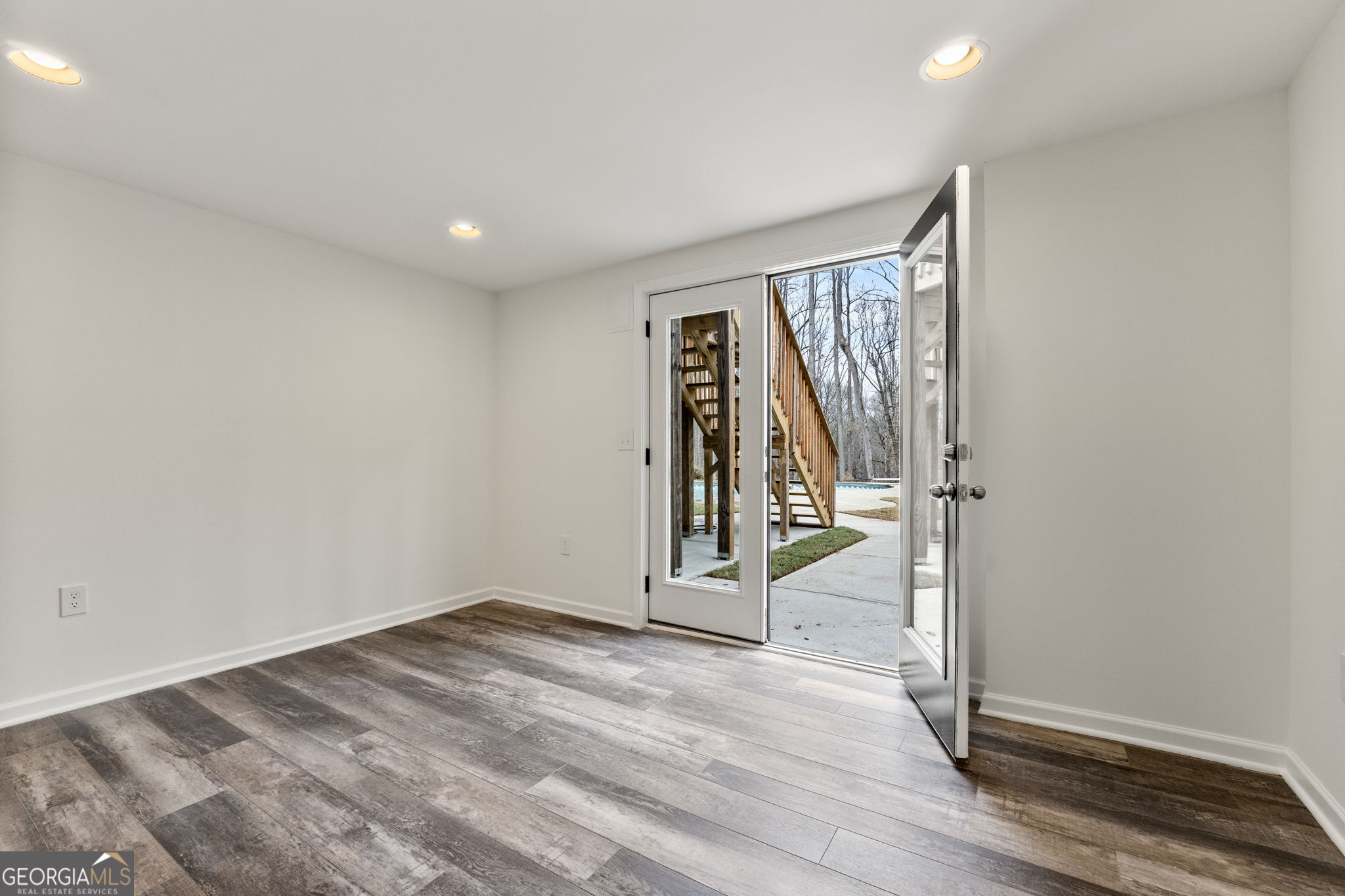 280 Antebellum Way Fayetteville, GA 30215 - Photo 64 of 65 an empty room with wooden floor and door
