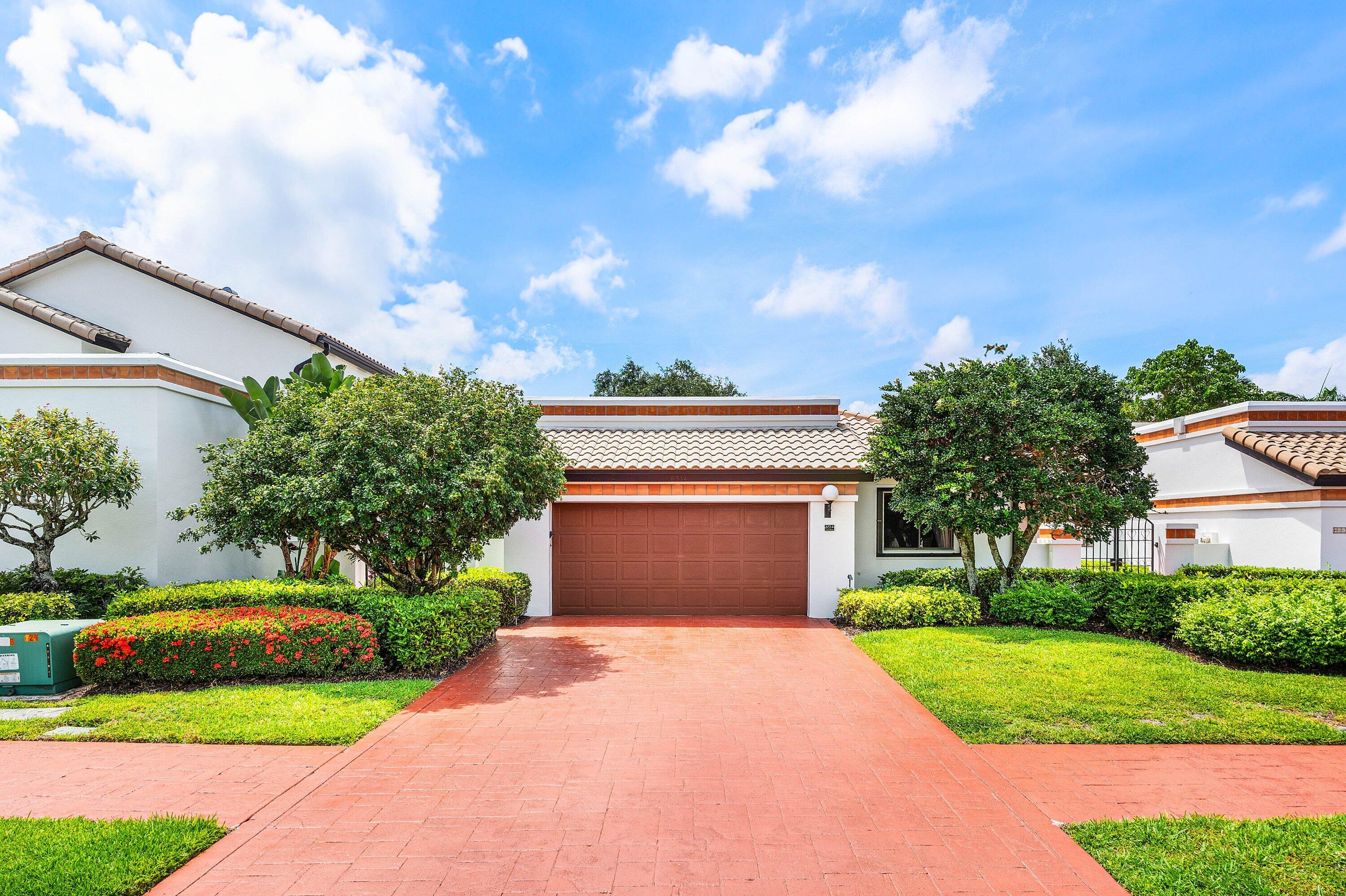 6514 Via Rosa Boca Raton, FL 33433 - Photo 1 of 27 a front view of a house with a yard and garage
