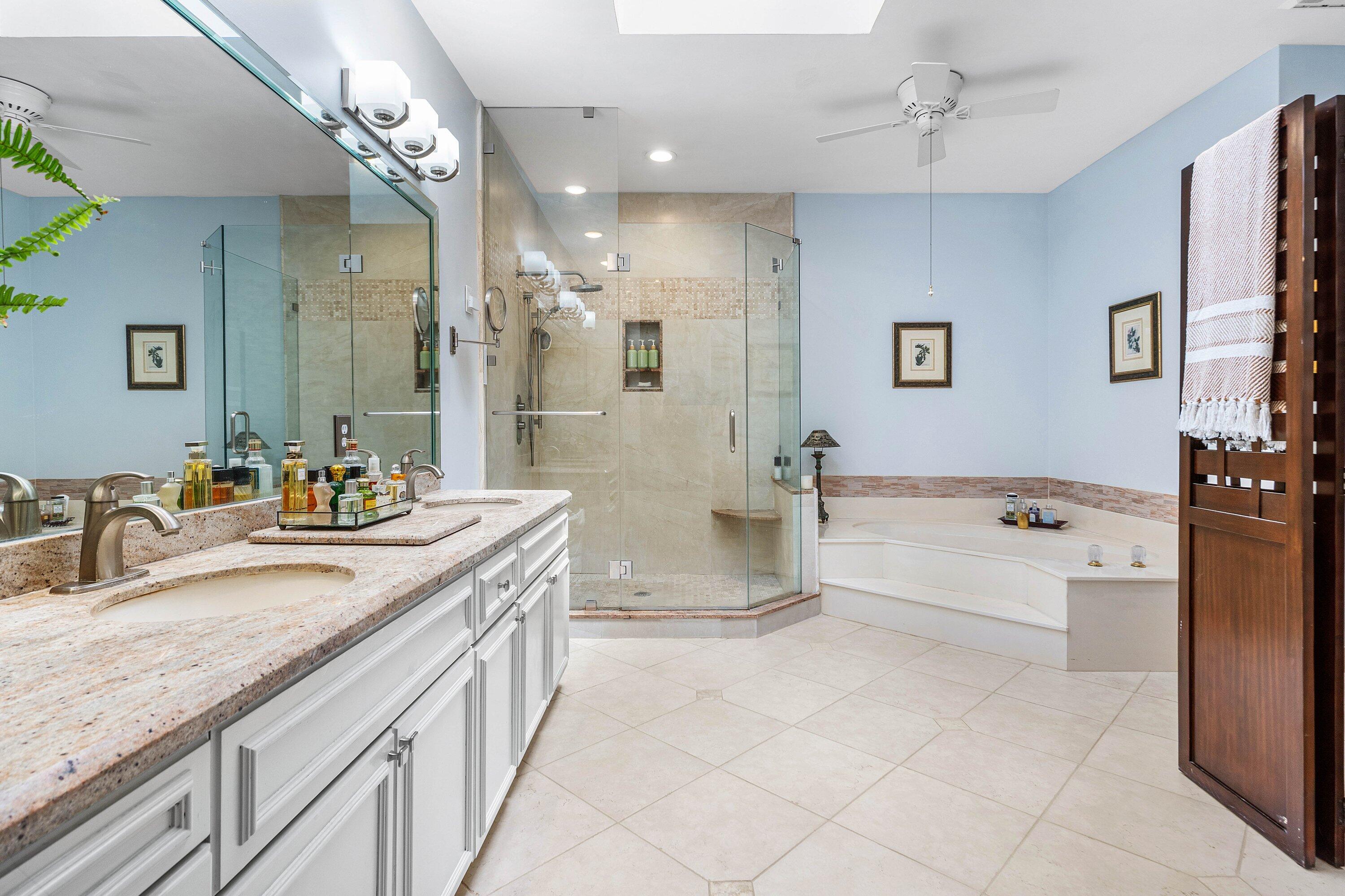 6514 Via Rosa Boca Raton, FL 33433 - Photo 18 of 27 a spacious bathroom with a granite countertop sink a mirror a bathtub and shower