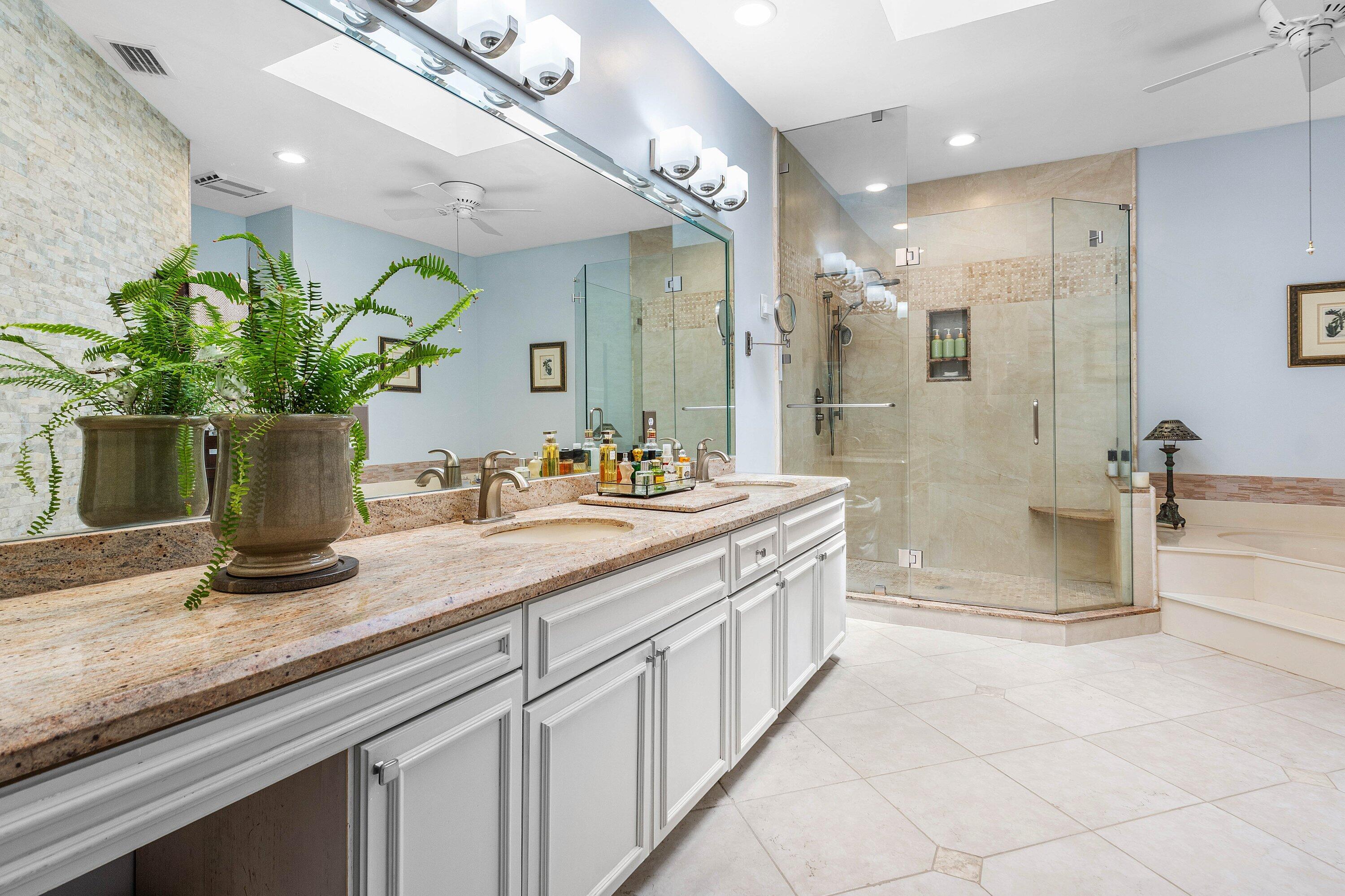 6514 Via Rosa Boca Raton, FL 33433 - Photo 20 of 27 a bathroom with a granite countertop sink a mirror and a shower