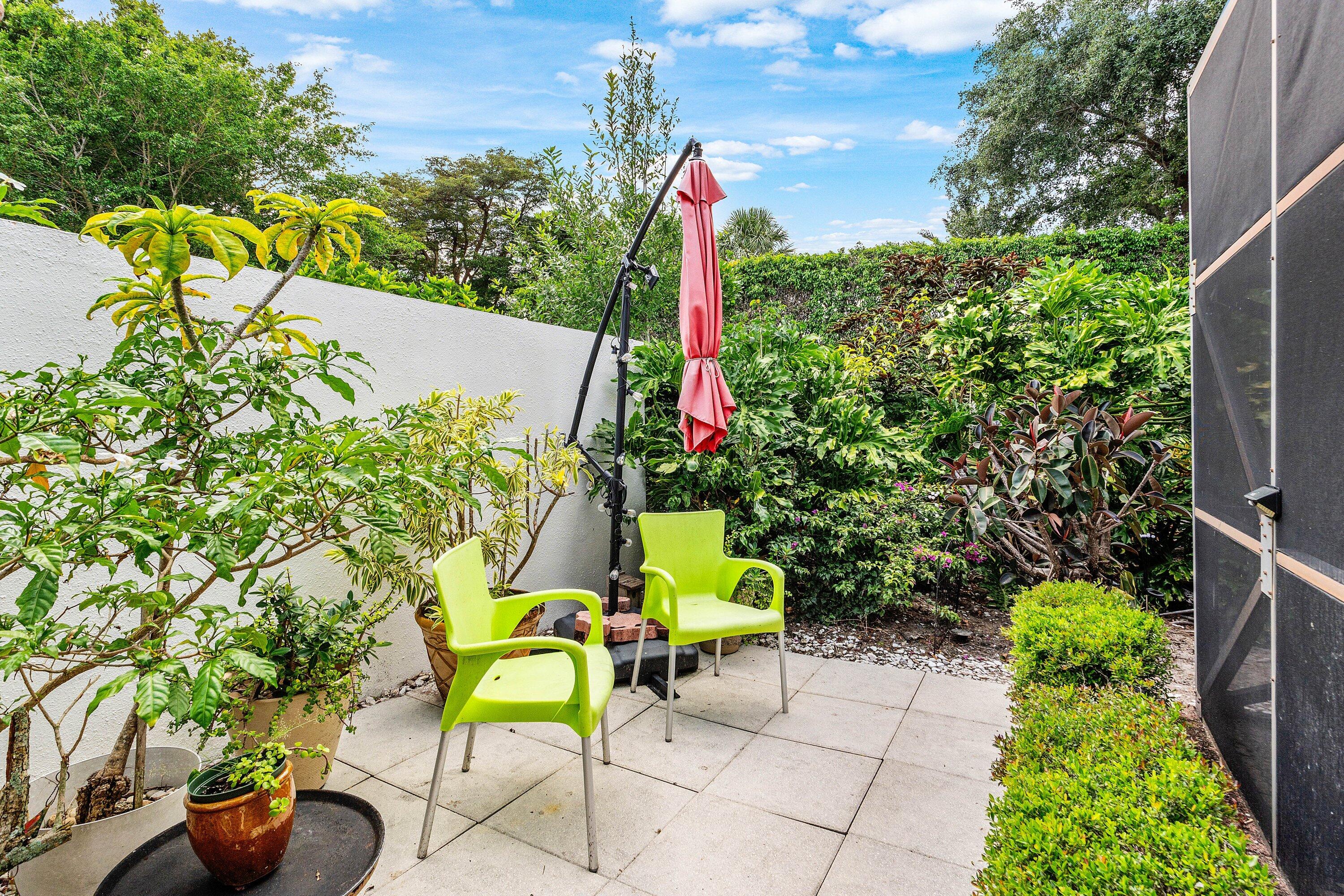 6514 Via Rosa Boca Raton, FL 33433 - Photo 25 of 27 a view of a backyard with plants and a fountain