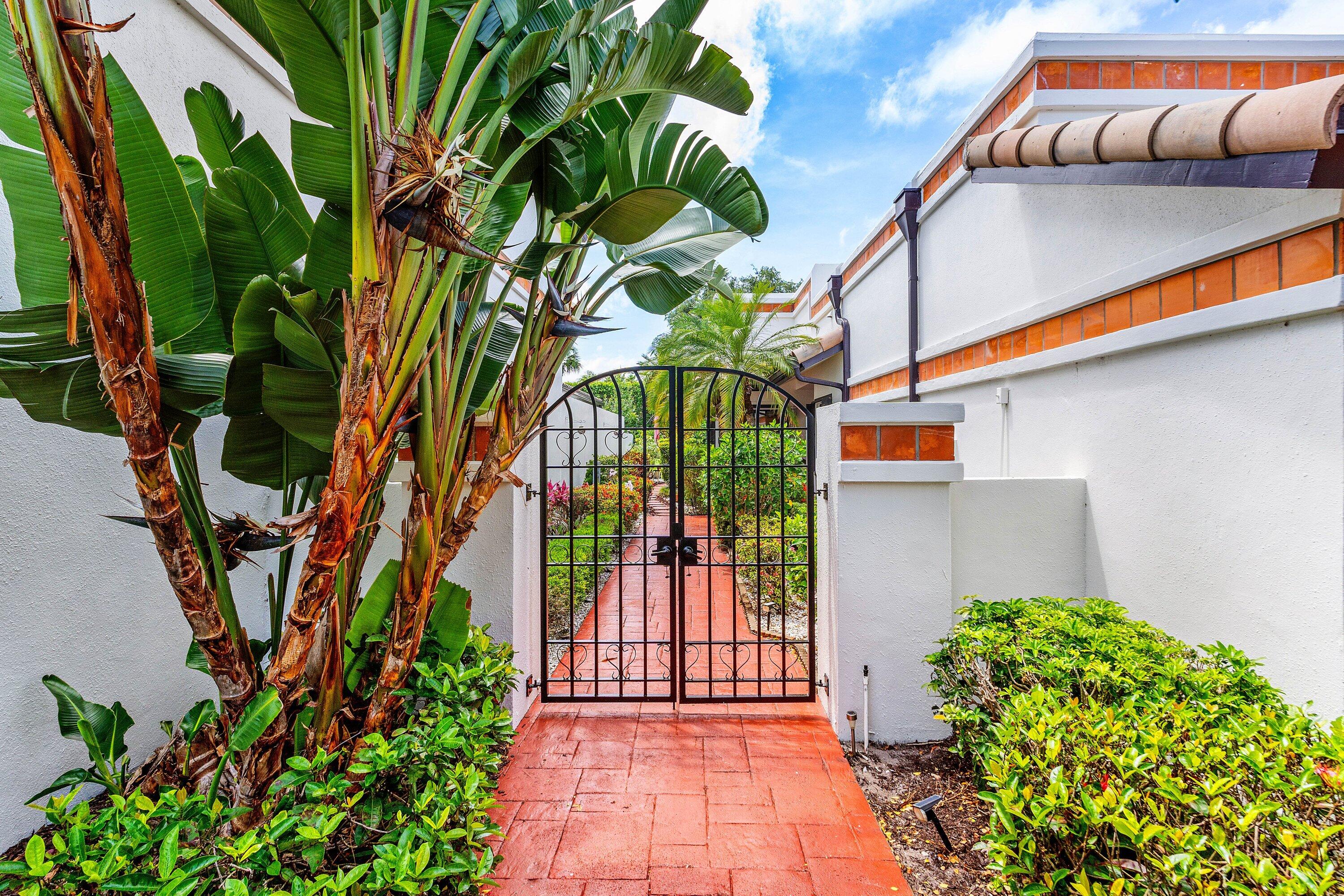 6514 Via Rosa Boca Raton, FL 33433 - Photo 3 of 27 a backyard of a house with a garden
