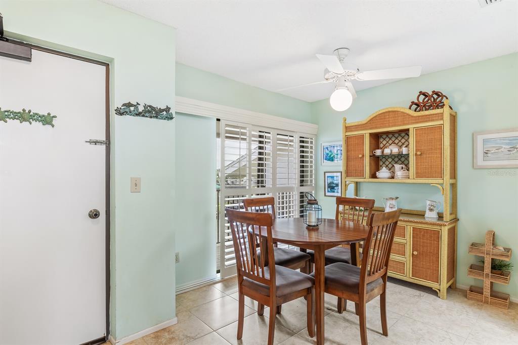 5000 Gasparilla Road, Unit 76B Boca Grande, FL 33921 - Photo 11 of 44 a view of a dining room with furniture window and wooden floor