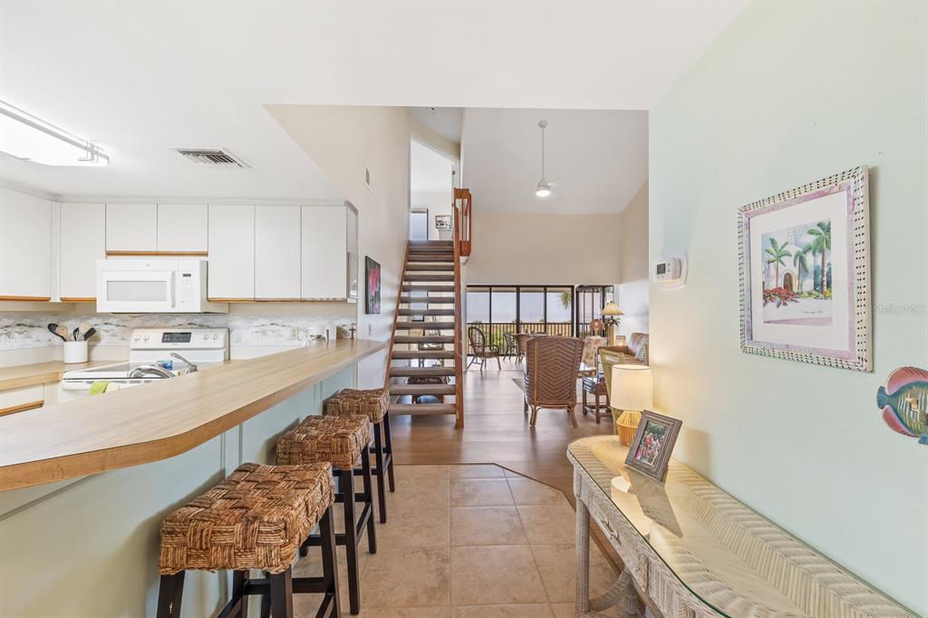 5000 Gasparilla Road, Unit 76B Boca Grande, FL 33921 - Photo 12 of 44 a large kitchen with a table and chairs