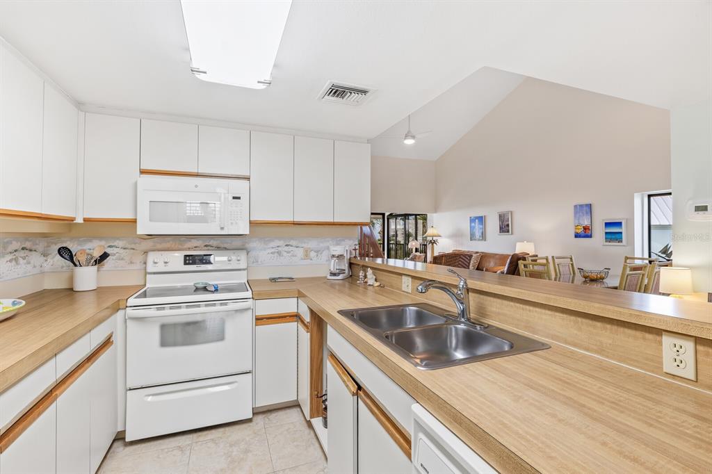 5000 Gasparilla Road, Unit 76B Boca Grande, FL 33921 - Photo 14 of 44 a kitchen that has a sink and a stove
